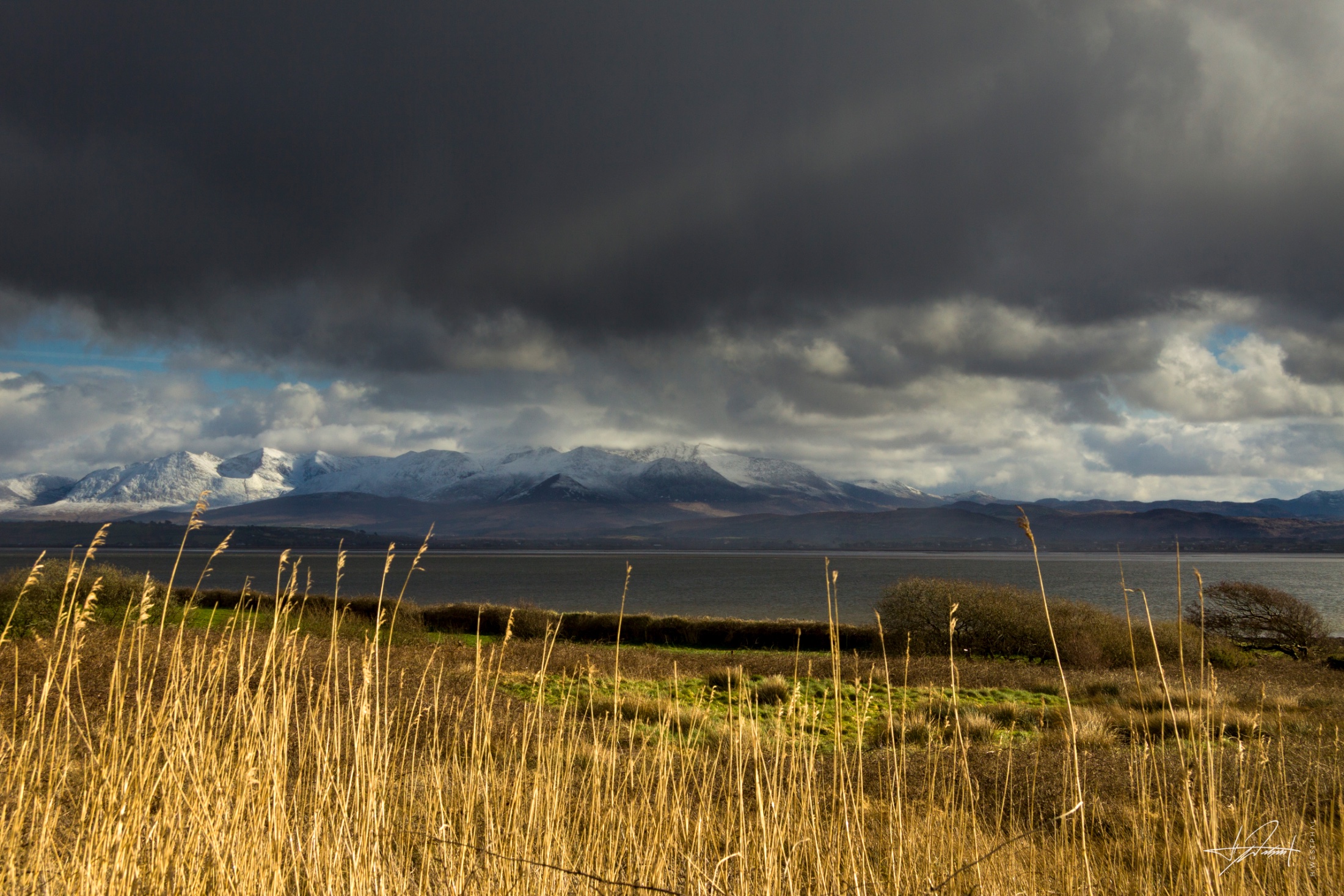Snow-capped mountains across Castlemaine Harbour, Ireland